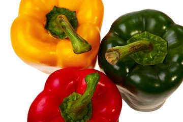 Three peppers red, green and yellow top view.
