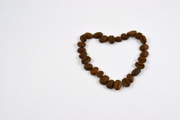 Heart from coffee grains on a white background