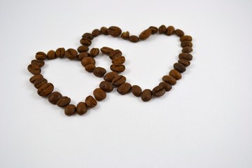 Two hearts from coffee grains are connected together