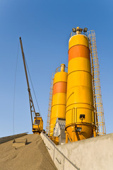 Obraz premium Yellow concrete silos over blue sky