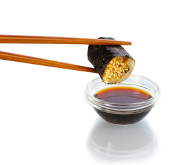 Dipping roll in sauce isolated on white