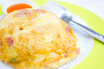 Rice, topped with omelette, dip chili sauce.