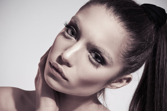 Fashion photo of young brunette woman with ideal skin