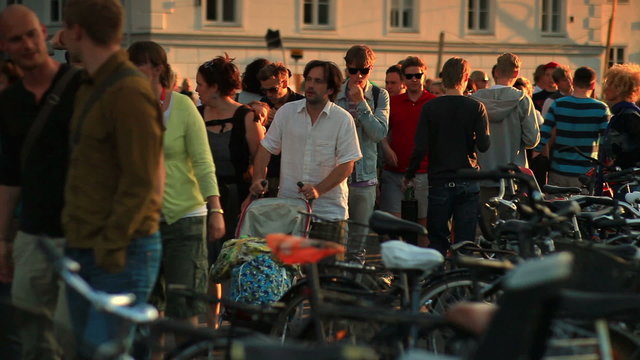 Bicycle rack and people walking in Copenhagen, Denmark.