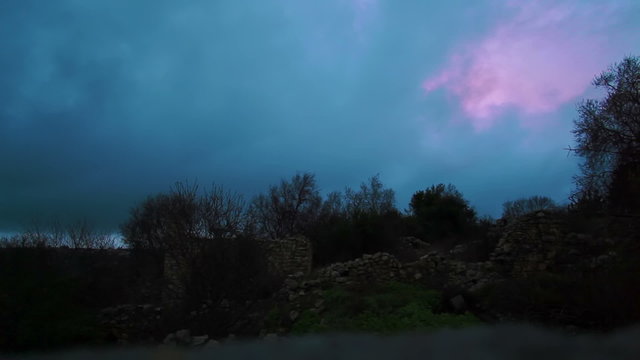Stock Video Footage of purple storm clouds over Bar'am ruins in Israel.