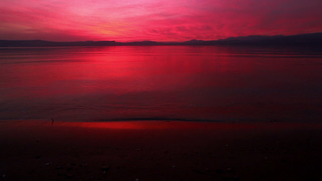 Stock Video Footage of a bright sunset reflecting off of the Sea of Galilee in Israel.