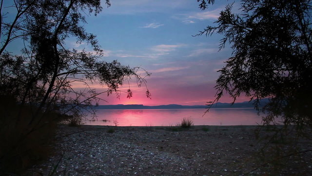 Stock Video Footage of a sunset from the shore of the Sea of Galilee in Israel.
