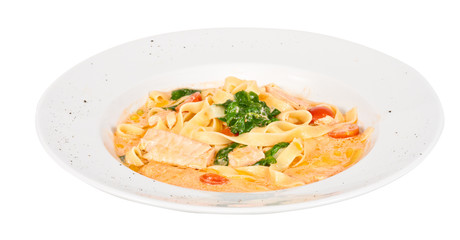 tasty pasta with cream, salmon, cheese and parsley close up