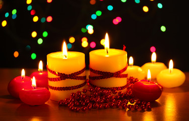 Beautiful candles and decor on wooden table on bright background