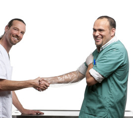 Vets shaking hands in front of white background