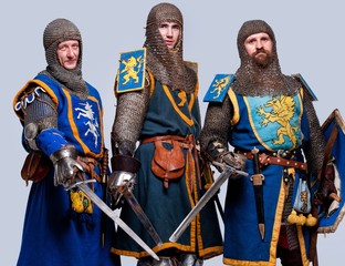 Three medieval knights isolated on grey background.