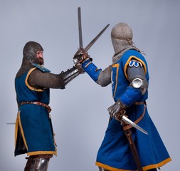 Two medieval knights fighting.