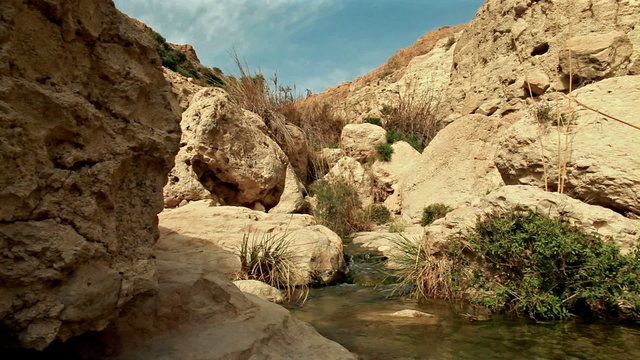 Stock Video Footage of a stream flowing between boulders in Israel.