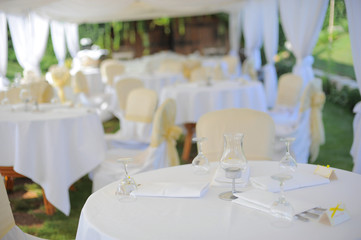 Decorated wedding tables outdoors. accent of glasses