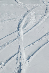 Snow background with ski and snowboard tracks