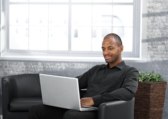 Businessman working in armchair