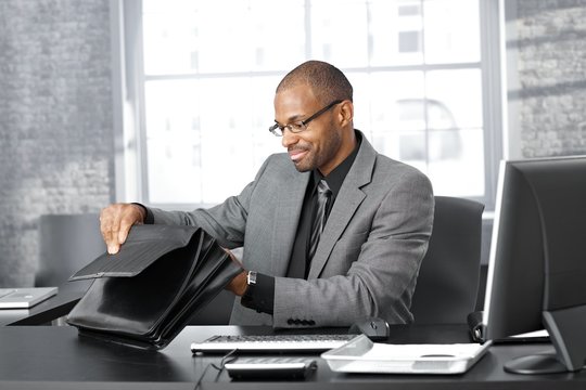 Businessman searching in briefcase