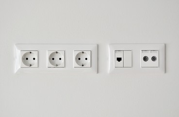 electrical, ethernet and tv or radio socket on the wall