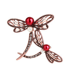 Beautiful golden brooch with precious stones isolated on white.