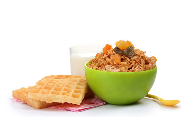 tasty cornflakes in green bowl and glass of milk isolated