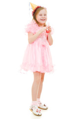 A girl in a pink dress and hat laughing on white background.