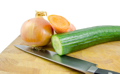 onion, carrot and cucumber on board