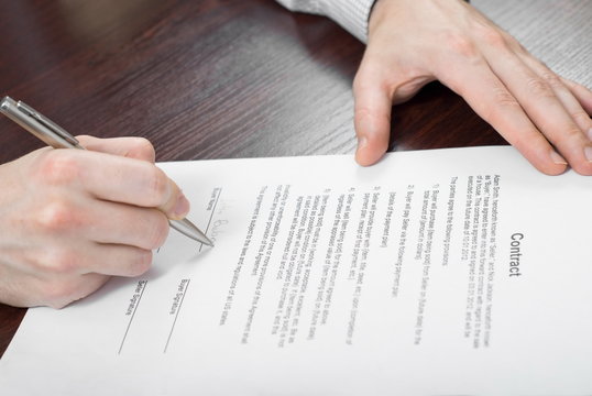 Signing contract by businessman