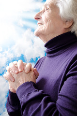 Christian religious senior woman praying to God