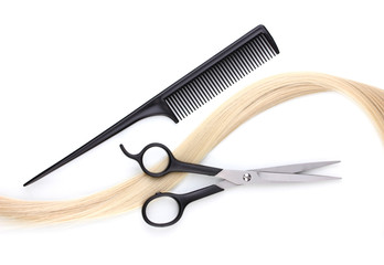 Shiny blond hair with hair cutting shears and comb isolated