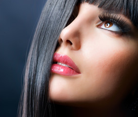 Fashion Brunette. Beautiful Makeup and Healthy Black Hair
