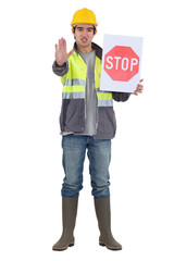 craftsman holding a stop sign