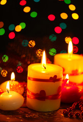 Beautiful candles on wooden table on bright background
