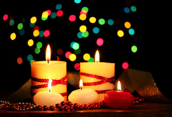 Beautiful candles and decor on wooden table on bright background