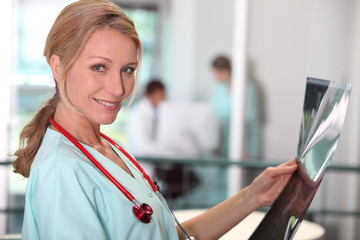 Female doctor looking at x-ray image