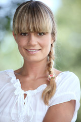Portrait of a pretty blonde woman with a blunt fringe