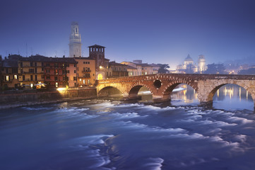 Ponte Pietra at a foggy evening. Verona - Italy.
