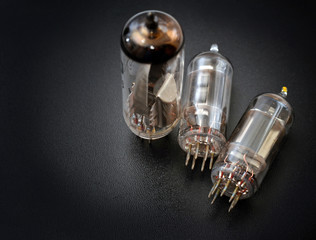Old radio tubes on black background