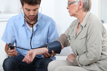 Doctor taking the blood pressure of a patient