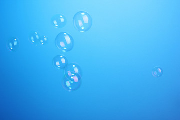 Soap bubbles on blue background