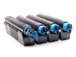 Four used color laser printer toner cartridges