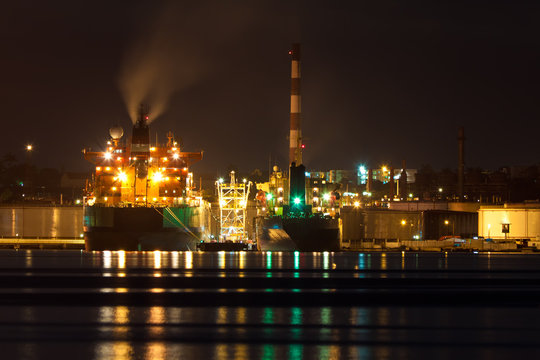 Oil tanker unloading cargo at night