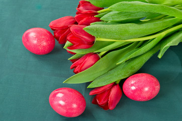 Pink eggs and red tulips as Easter concept