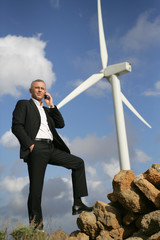 Man on the phone in front of the windmill