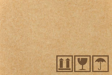 Safety fragile icon on cardboard paper box with space