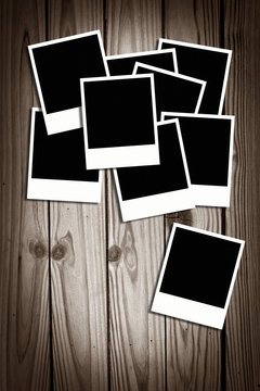 blank instant photos on old wood background with copy space