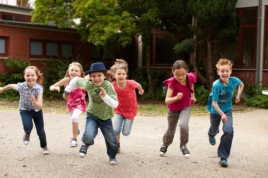 Gruppe Kinder l&auml;uft auf Schulhof