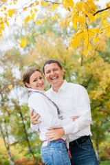 Romantic young beautiful couple on autumn walk