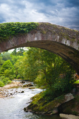 Fototapeta na wymiar Old bridge over Miera river in Lierganes town. Cantabria