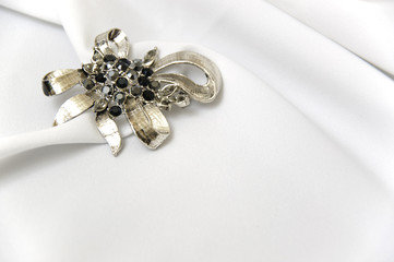 White satin and brooch
