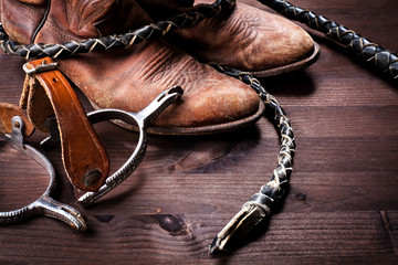 Cowboy boots,whip and spurs on wood - obrazy, fototapety, plakaty